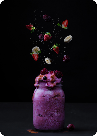 Image of a glass with strawberry, banana and blackberry ice cream